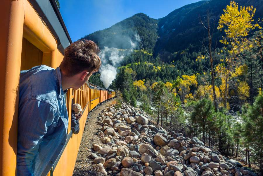 Man looking out of train window on the historic steam engine train in Durango, Colorado